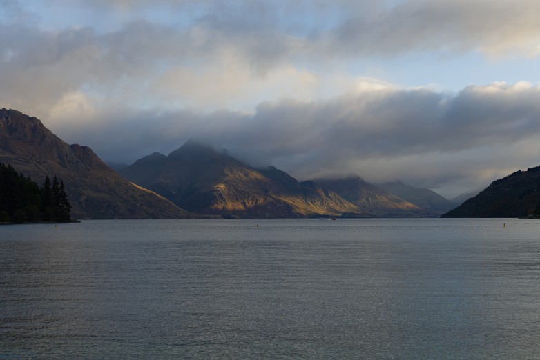 Cloud sitting low over the mountains across Lake Wakatipu in late afternoon light