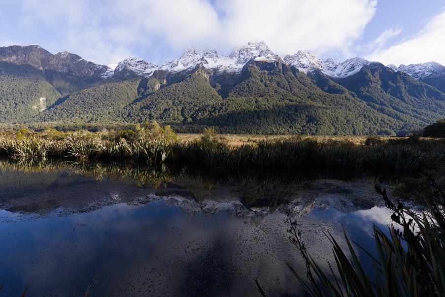 Snow-covered peaks of the Earl Mountains reflected in the still water at Mirror Lakes
