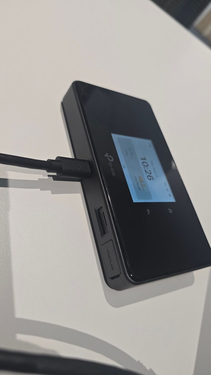 M8550 seen from the edge showing the USB-C cable, nano SIM slot and gigabit WAN/LAN port